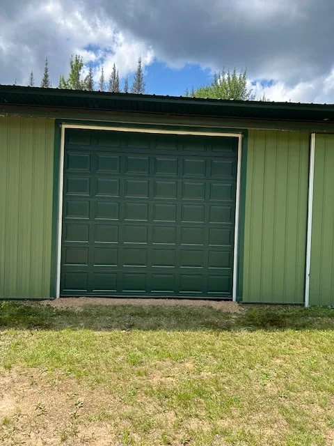 Commercial green overhead door on a metal building