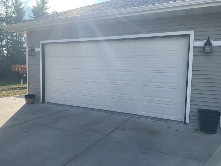 New white insulated steel garage door on a Midwest home