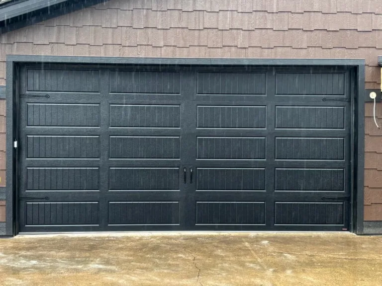 Black carriage-style garage door with decorative hardware